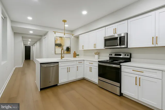 a kitchen with granite countertop white cabinets and white appliances
