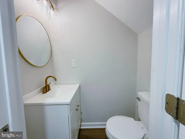 a bathroom with a sink a toilet and a mirror