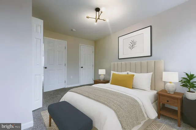 a bedroom with a bed and a painting on the wall