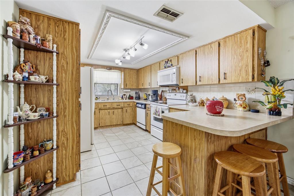 5141 East Backner Lane Inverness, FL 34452 - Photo 12 of 31 a kitchen with a sink appliances and cabinets
