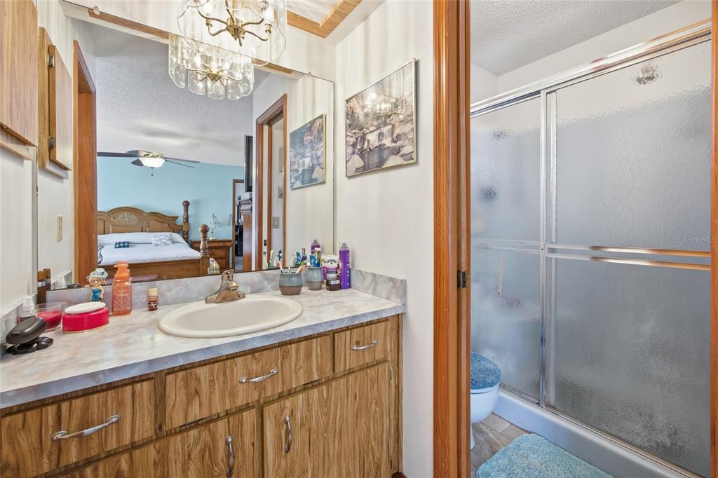 5141 East Backner Lane Inverness, FL 34452 - Photo 21 of 31 a bathroom with a sink vanity granite shower and a mirror