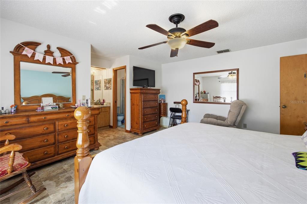 5141 East Backner Lane Inverness, FL 34452 - Photo 22 of 31 a bedroom with a bed and a chandelier
