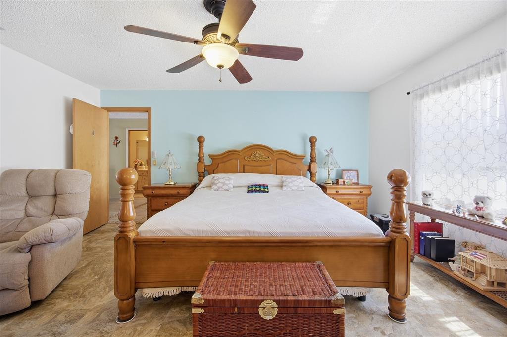 5141 East Backner Lane Inverness, FL 34452 - Photo 23 of 31 a bedroom with a bed and a chandelier