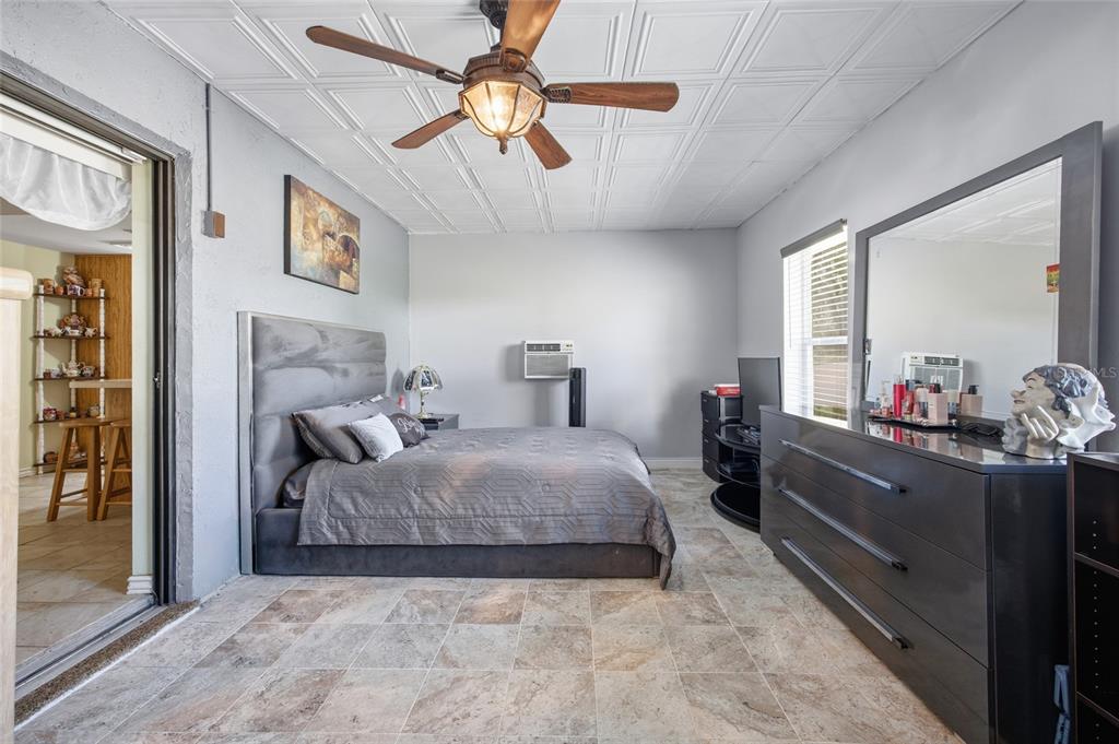 5141 East Backner Lane Inverness, FL 34452 - Photo 26 of 31 a bedroom with a bed and a chandelier