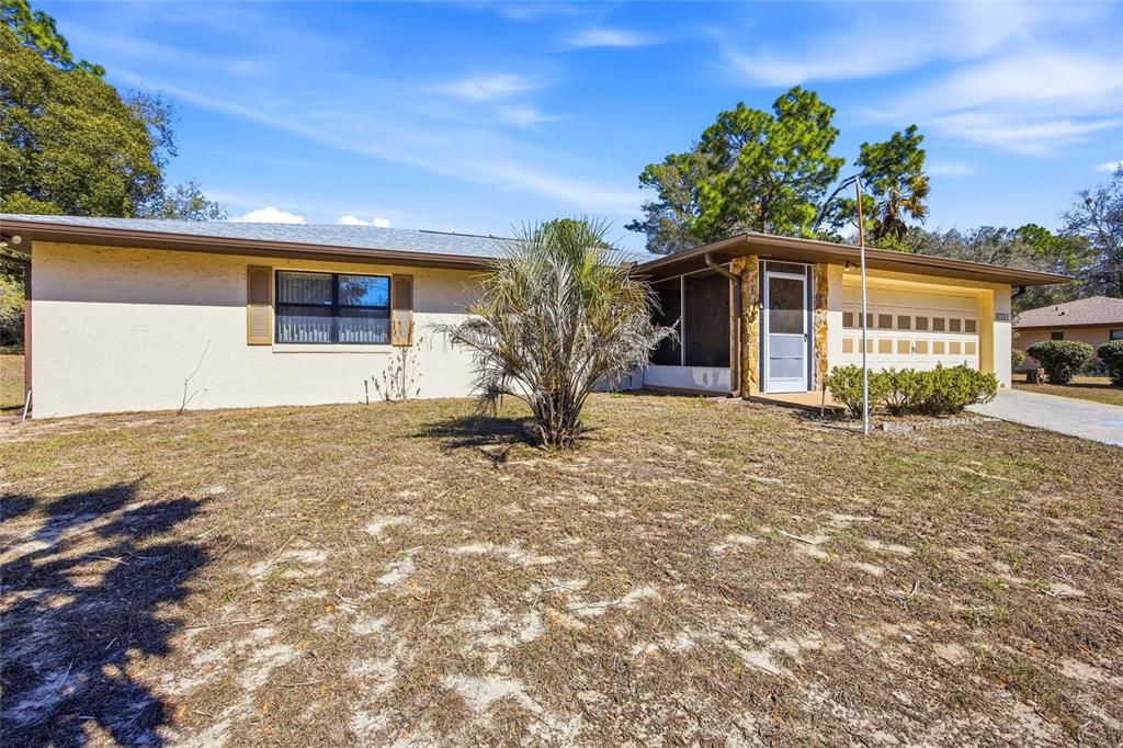 5141 East Backner Lane Inverness, FL 34452 - Photo 3 of 31 a front view of a house with garden