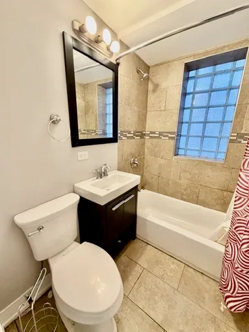 a bathroom with a sink a toilet and bathtub