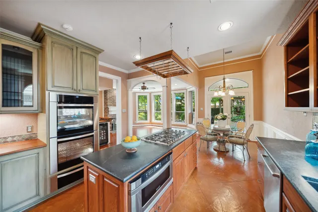 a kitchen with stainless steel appliances granite countertop a stove and a refrigerator
