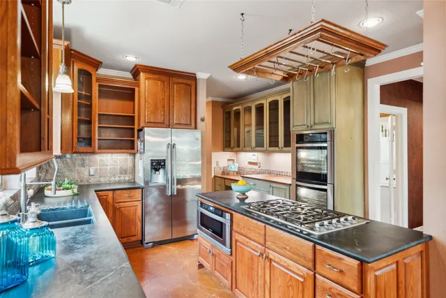 a kitchen with stainless steel appliances granite countertop a stove and a refrigerator