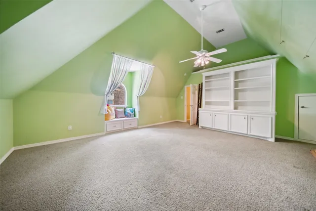 a view of empty room with cabinet and ceiling fan