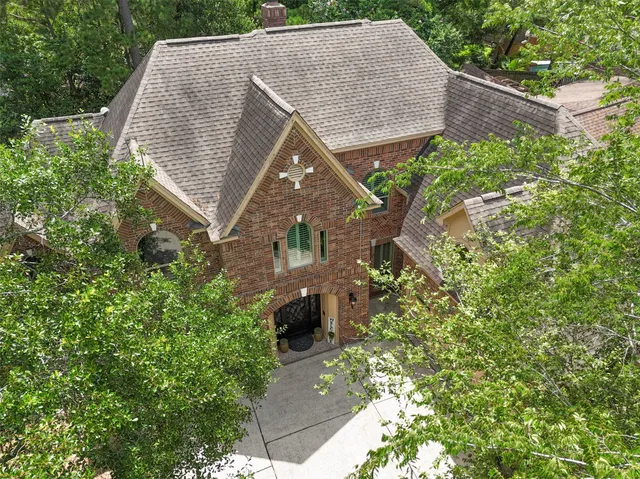 a aerial view of a house with a yard and potted plants