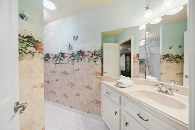 a bathroom with a bathtub sink and mirror