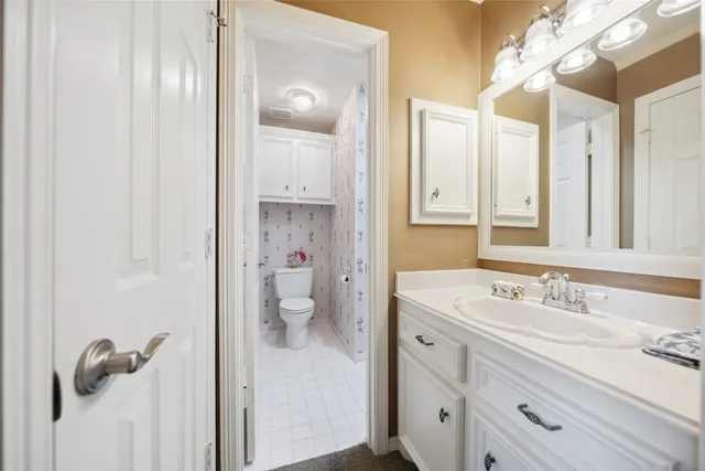a spacious bathroom with a shower sink and mirror