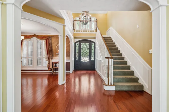 a view of an entryway with wooden floor