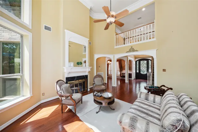 a living room with furniture a fireplace and a window