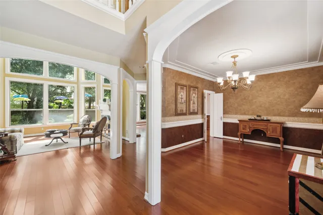 a view of a livingroom with furniture wooden floor and a chandelier