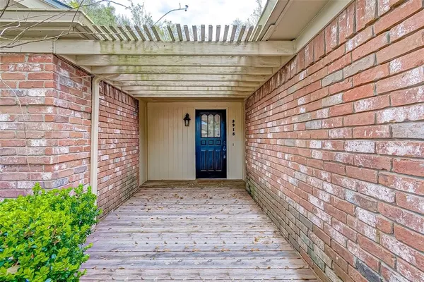 a view of entrance with a brick wall