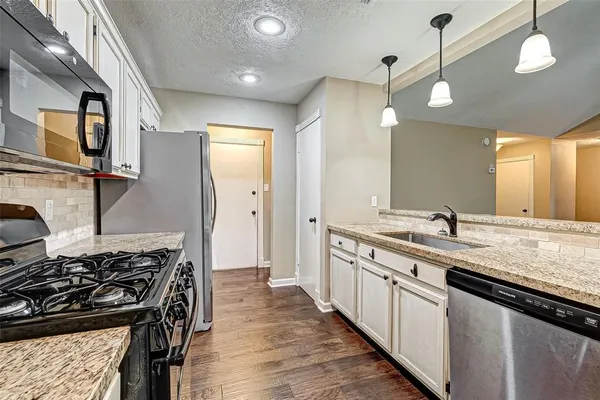 a kitchen with a stove and a sink