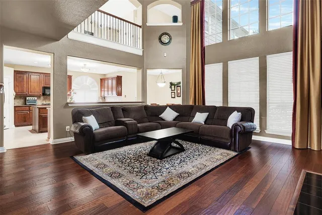 a living room with furniture wooden floor and a large window