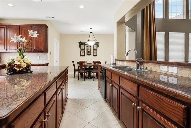 a kitchen with sink a counter and cabinets