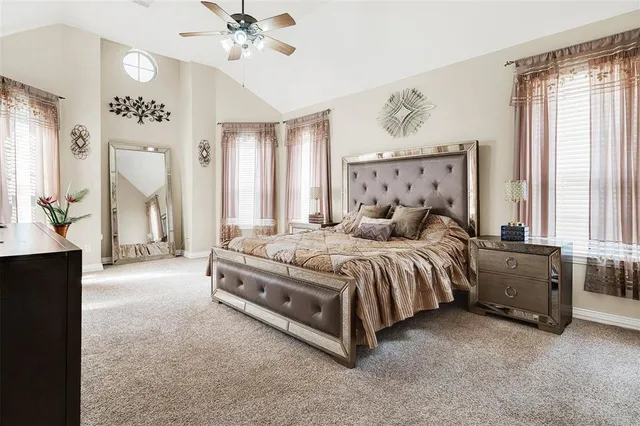 a spacious bedroom with a bed and a chandelier