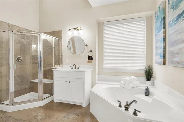 a bathroom with a tub sink and mirror