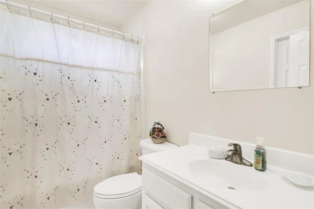 a bathroom with a sink a toilet and vanity