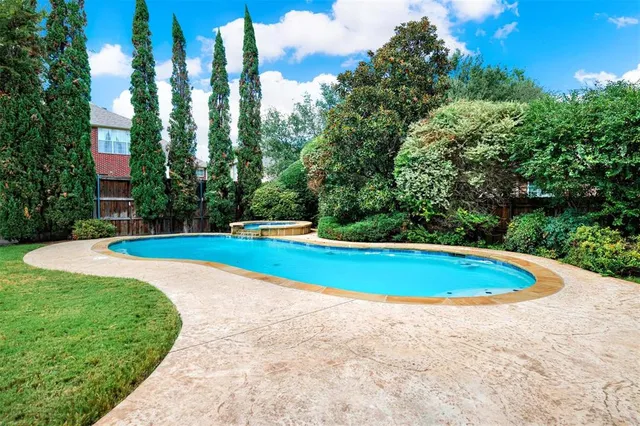 a view of a swimming pool with a yard