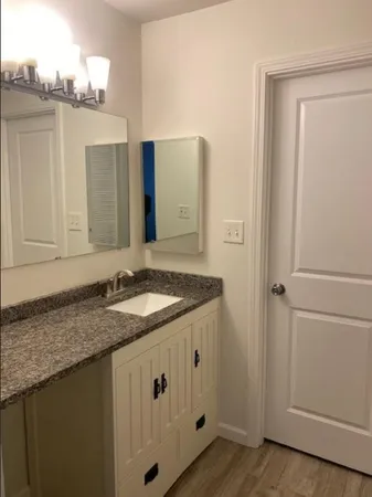 a white toilet sitting next to a bath tub