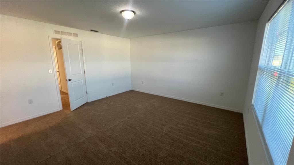 1064 Appleton Street Davenport, FL 33837 - Photo 21 of 28 an empty room with a empty space and window