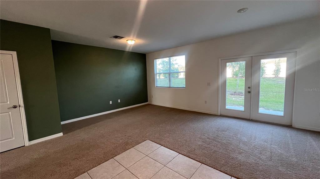 1064 Appleton Street Davenport, FL 33837 - Photo 5 of 28 an empty room with windows