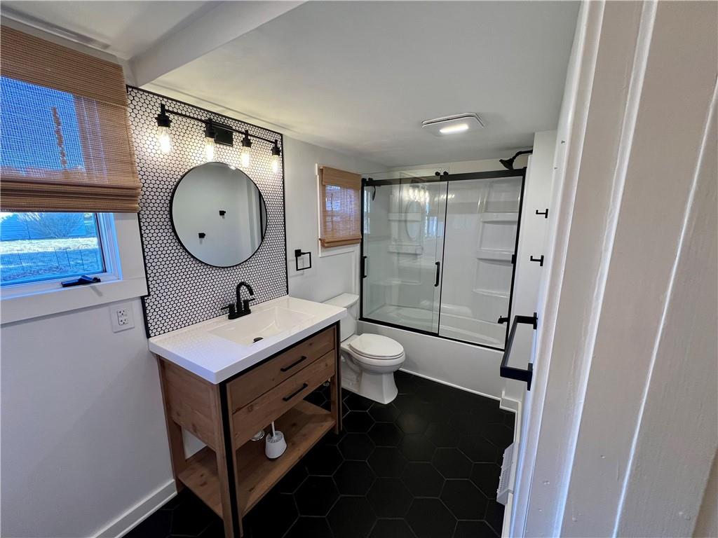 142 Alexander Avenue Strabane, PA 15363 - Photo 15 of 25 a bathroom with a toilet a sink and mirror