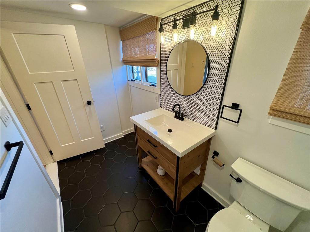 142 Alexander Avenue Strabane, PA 15363 - Photo 16 of 25 a bathroom with a sink toilet and a mirror