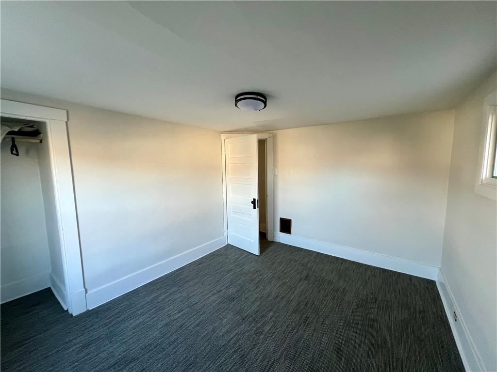 142 Alexander Avenue Strabane, PA 15363 - Photo 20 of 25 an empty room with wooden floor and windows