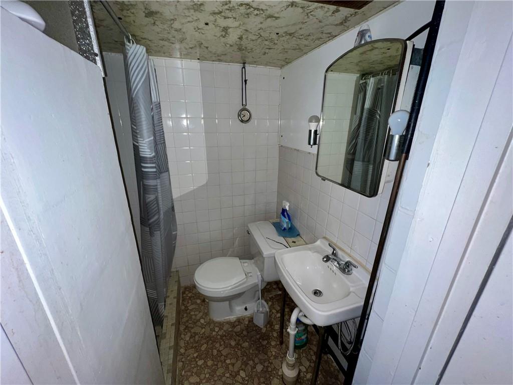 142 Alexander Avenue Strabane, PA 15363 - Photo 22 of 25 a bathroom with a sink toilet and mirror