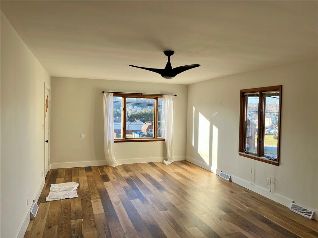 142 Alexander Avenue Strabane, PA 15363 - Photo 9 of 25 a view of an empty room with a window and wooden floor