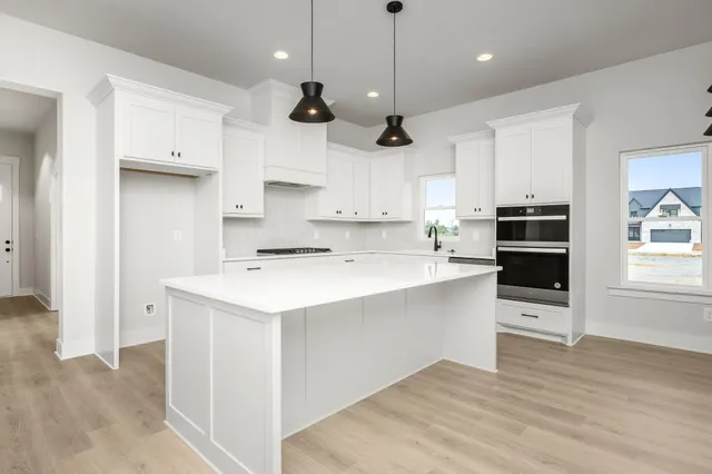 a kitchen with a stove a sink and a refrigerator