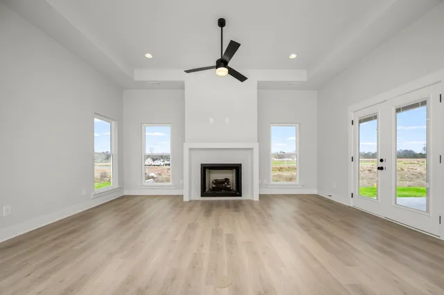 a view of an empty room with window and fire place