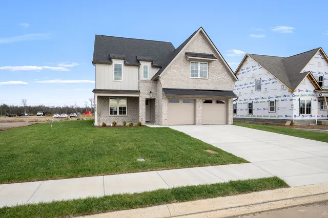 a front view of a house with a yard and garage