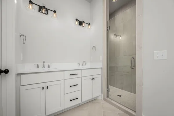 a bathroom with a shower sink and mirror