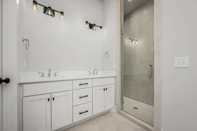 a bathroom with a shower sink and mirror