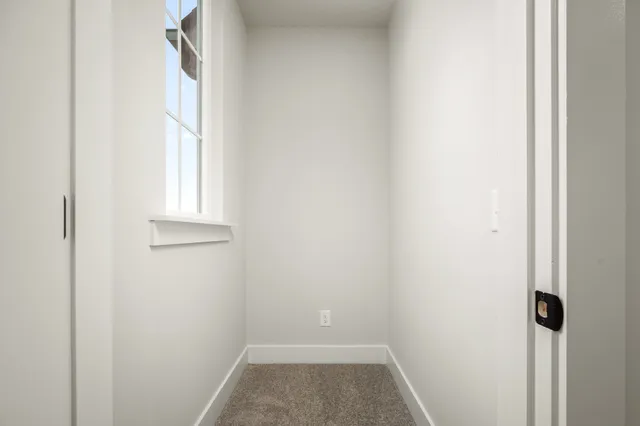 a view of small space with wooden floor and a window