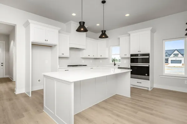 a kitchen with a stove a sink and a refrigerator