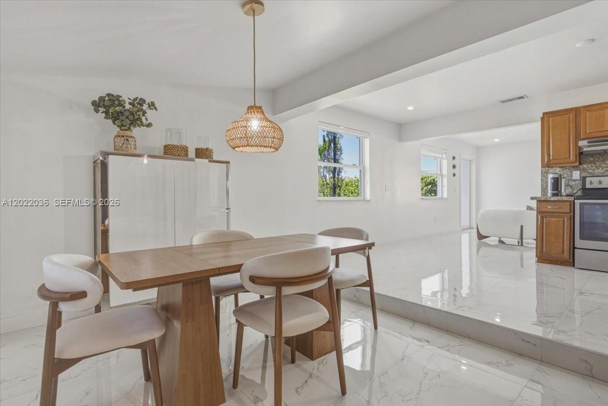 120 West 50th Street Hialeah, FL 33012 - Photo 8 of 22 a view of a dining room with furniture and chandelier