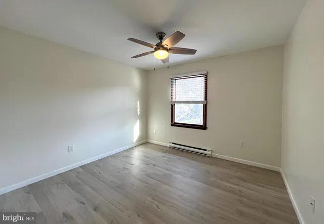 wooden floor in an empty room with a window