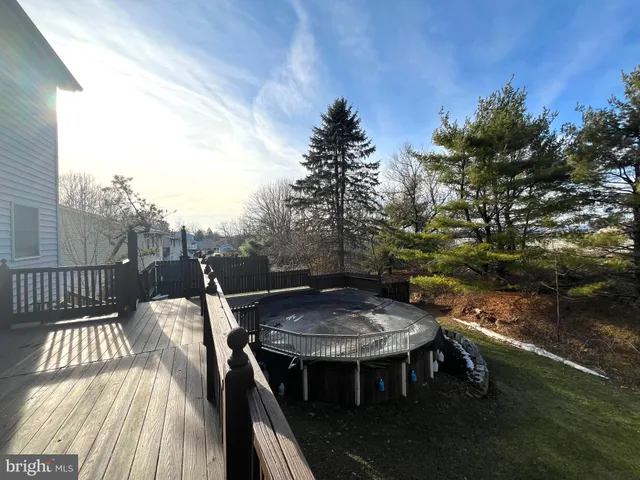 a balcony with wooden floor and fence