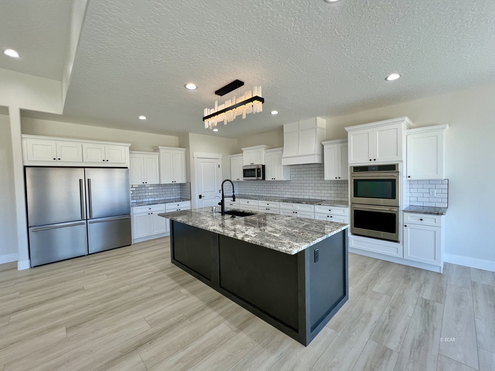 1597 Sun Vly Road, Unit C7 Spring Creek, NV 89815 - Photo 8 of 43 a kitchen with stainless steel appliances granite countertop a stove and a refrigerator
