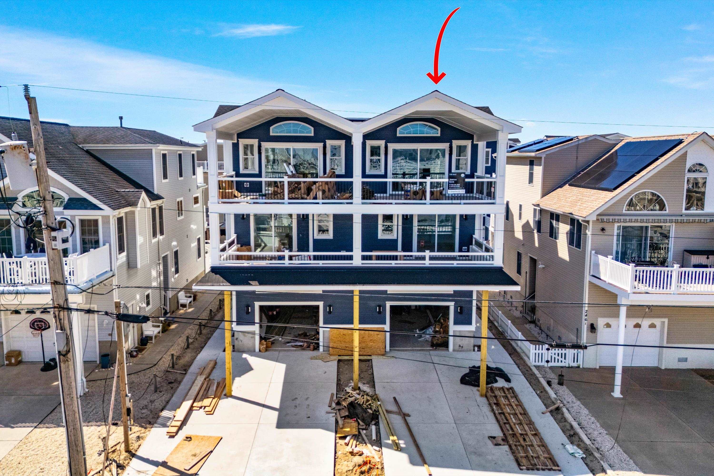 242 57th Street, Unit WEST Sea Isle City, NJ 08243 - Photo 1 of 20 a front view of a house with a yard