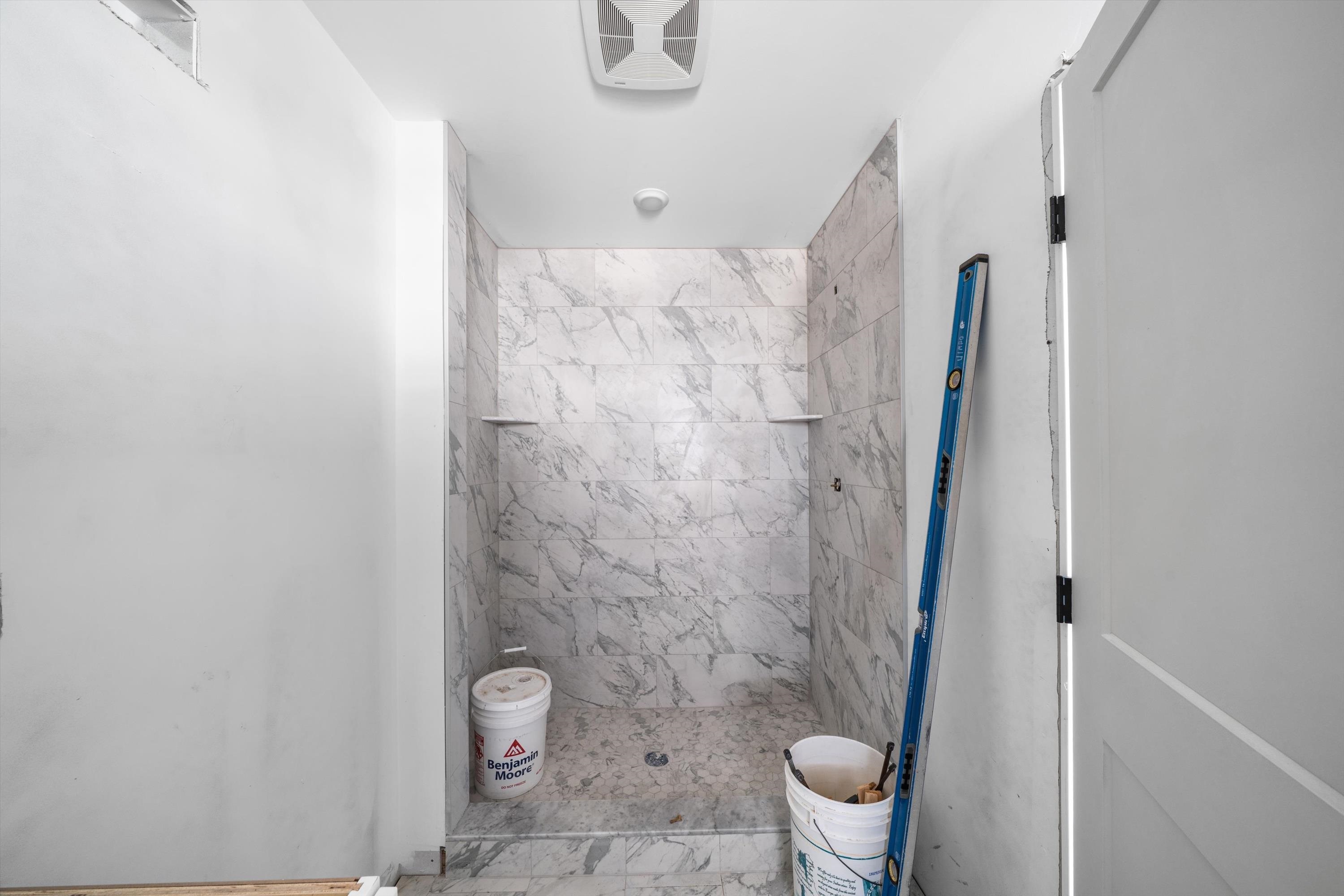 242 57th Street, Unit WEST Sea Isle City, NJ 08243 - Photo 12 of 20 a bathroom with a granite countertop sink toilet and shower