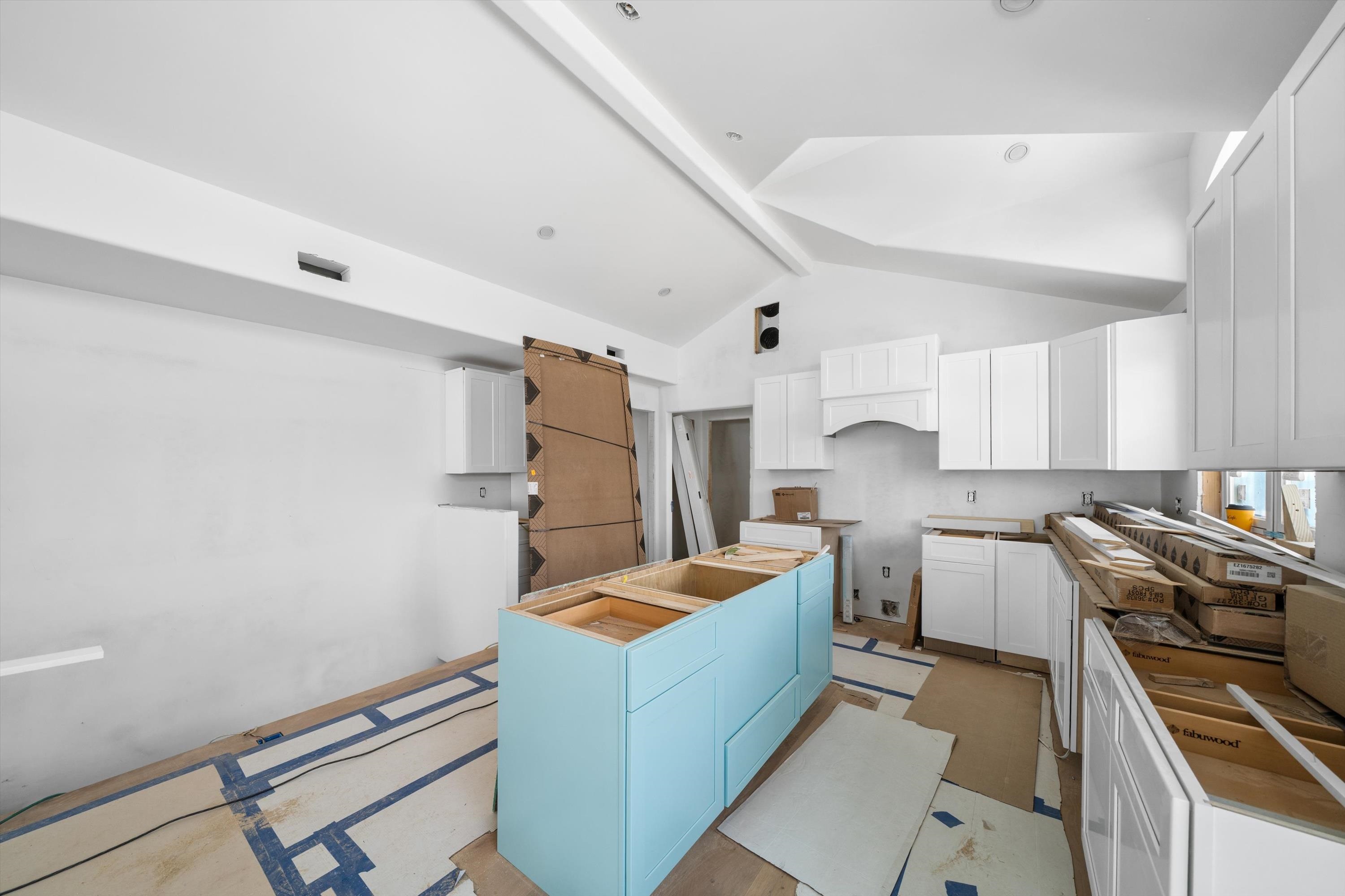 242 57th Street, Unit WEST Sea Isle City, NJ 08243 - Photo 14 of 20 a kitchen with blue cabinets and stainless steel appliances
