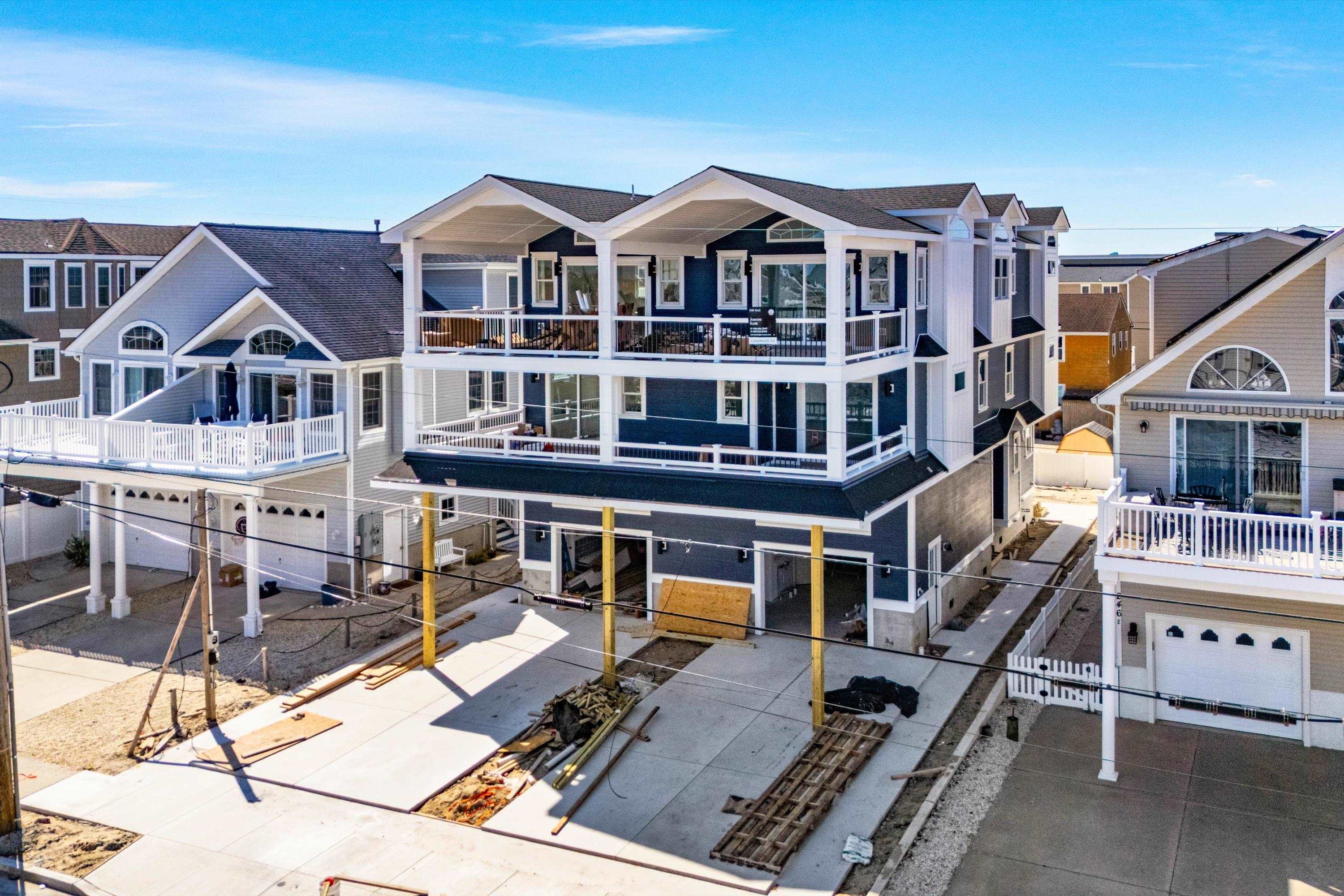 242 57th Street, Unit WEST Sea Isle City, NJ 08243 - Photo 17 of 20 an aerial view of a house with a porch